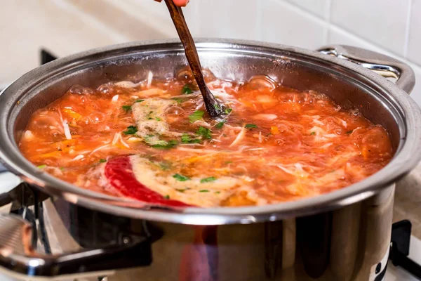 Freshly made borscht boiling in saucepan close — Stock Photo, Image