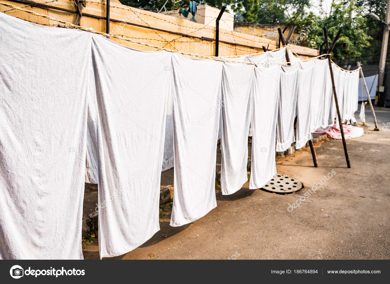 White sheets hang on ropes in Indian street — Stock Photo © Yakov_Oskanov  #186764894, image size:1600x1168