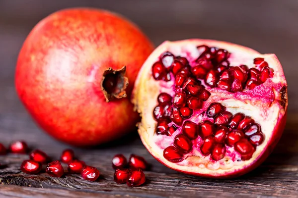 Ripe pomegranate fruits on wooden background — Stock Photo, Image