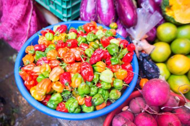Different colorful peppers for sale in market clipart