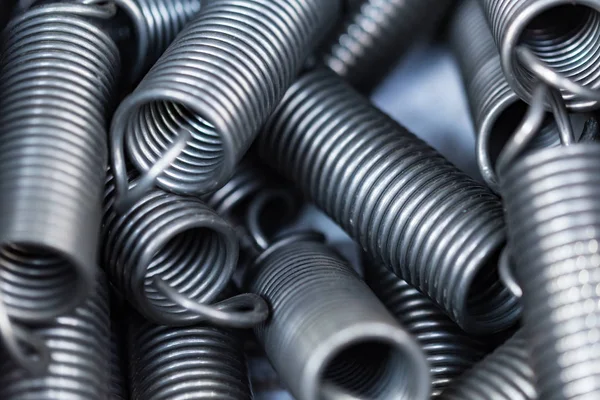 Closeup of shiny galvanized coiled helical springs — Stock Photo, Image