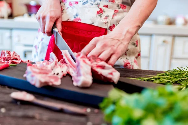 Cook chops raw lamb ribs on kitchen table close up — Stock Photo, Image