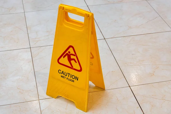 Wet floor caution sign on floor close — Stock Photo, Image