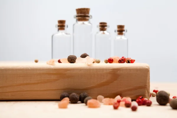 Small glass bottles with red pepper and reflexions — Stock Photo, Image