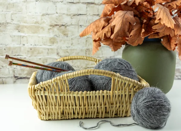 Wicker basket with skeins of yarn. Autumn still life. — Stock Photo, Image