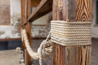 Kalın bir ip ahşap bir direğe bağlanır..