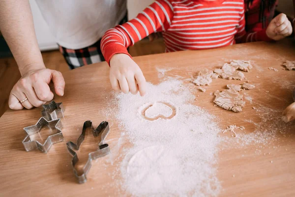 Family baking cookies together at home kitchen.