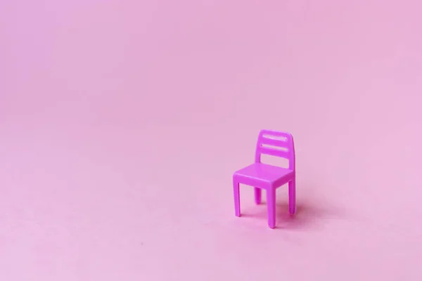 One chair on the pink background. Minimal pandemic and incarceration in state of quarantine concept. Social problems. The consequences of coronavirus. Creative background. Copy space.
