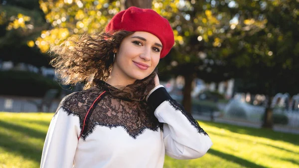 Mulher ligeiramente vintage com chapéu vermelho em um parque, roupas, moda, ao ar livre Imagens Royalty-Free