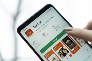 New York - January 9, 2020: Tantan application on a smartphone with a finger above the screen. Tantan is a mobile social dating platform designed to find and interact with new people.