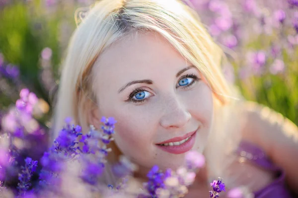 Beautiful girl in a field of lavender on sunset. Stock Picture