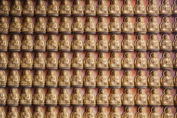 Buda chinês dourado estátua padrão no fundo da parede . — Fotografia de Stock
