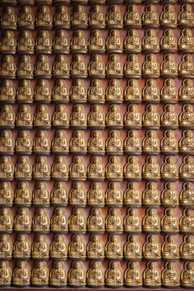 Золотая китайская статуя Будды на фоне стены . — стоковое фото