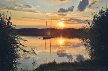 Boats on a beautiful lake. Evening summer landscape by the water.