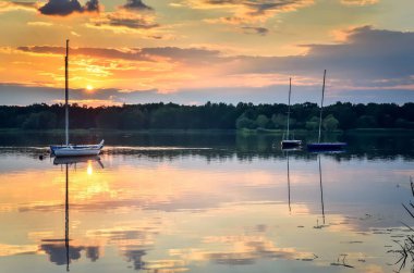 Boats on a beautiful lake. Evening summer landscape by the water.