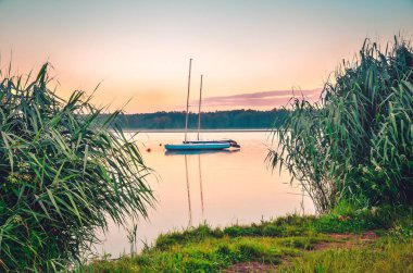 Boats on the water. Morning landscape by the lake.