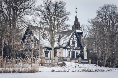 Beautiful historic castle in a winter scenery. Historic Hunting Palace in Promnice in Kobior, Poland.