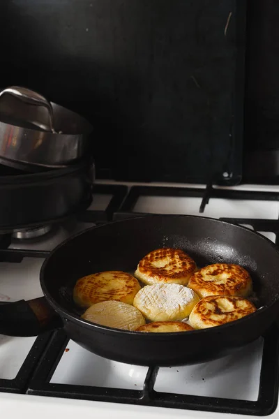 Cheese pancakes in frying pan — Stock Photo, Image