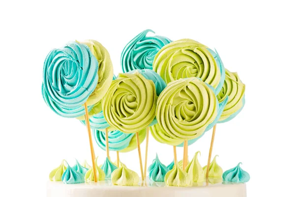 Green and blue lollipops meringues candy on wooden stick — Stock Photo, Image