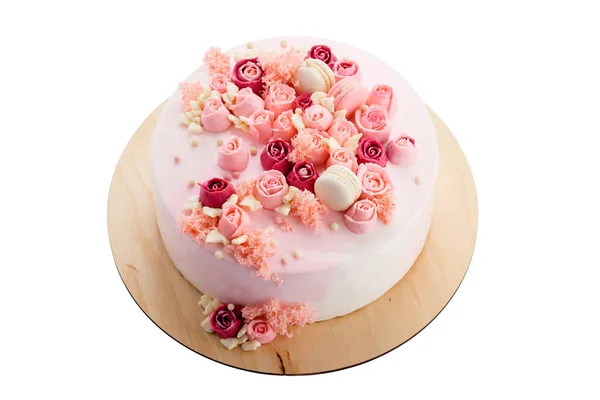 Pink glazed cake with cream flowers isolated on white — Stock Photo, Image