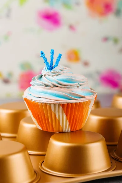 Blue cupcake in orange cup — Stock Photo, Image