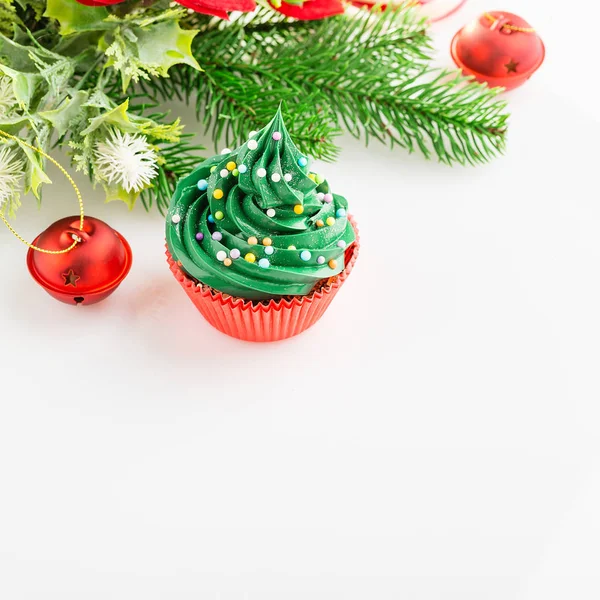 Christmas cupcake in red cup with festive decorations on white b — Stock Photo, Image
