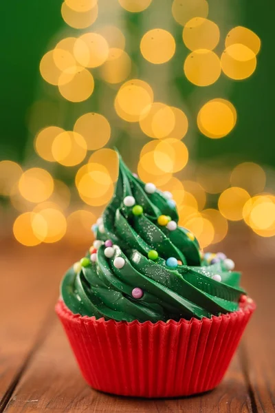Green christmas cupcake with bokeh on background