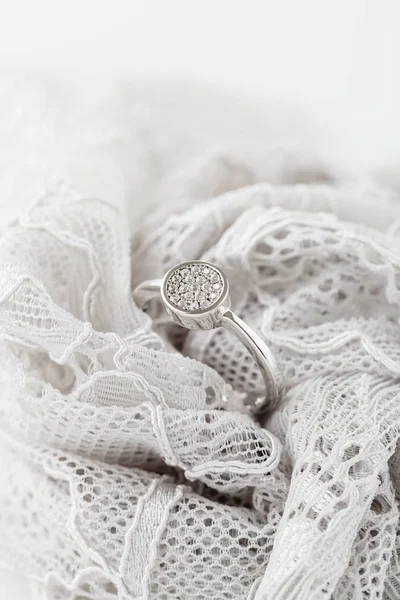 Wedding or engagement silver ring on lace — Stock Photo, Image