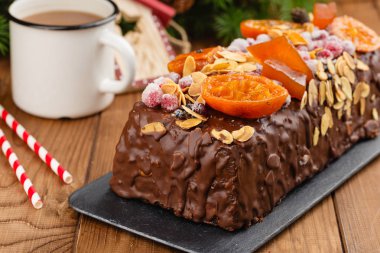 Traditional christmas fruit cake pudding in chocolate glaze clipart