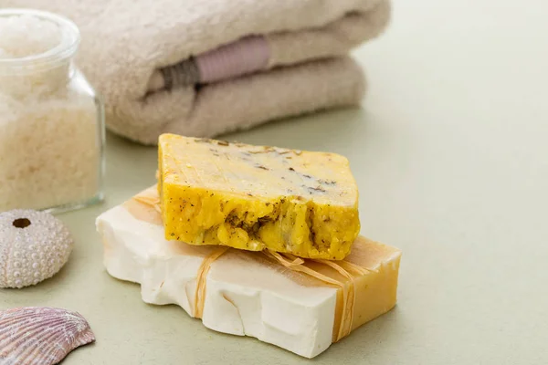 Yellow bars of natural organic soap with honey and dried herbs