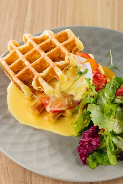 Savory Belgian waffles with mustard sauce and salad