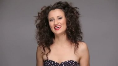 Genç esmer, uzun kahverengi kıvırcık saçlı dans eden