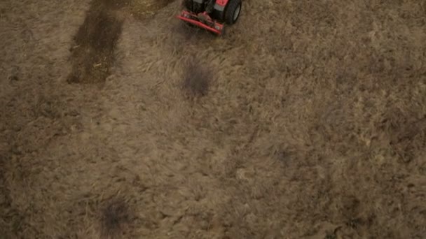 Farmland aerial view with a tractor plowing soil — Stock Video