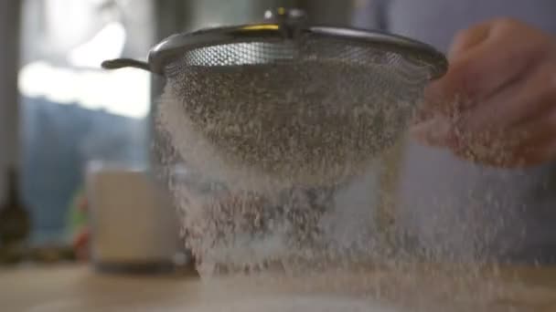 Woman sifting flour through a sieve — Stock Video