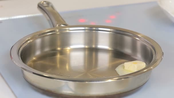 Piece of butter is melting on a pan — Stock Video