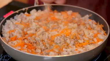 Minced meat with onions and carrots stewed in a pan