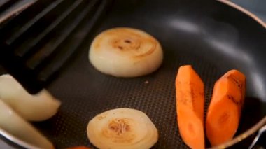 Et suyu için sebzeler kızartma tavasında pişirilir.