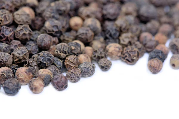 Black pepper on white background Royalty Free Stock Images