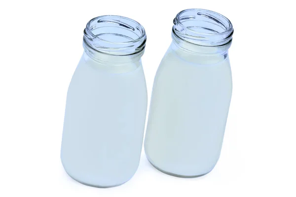 Leche en dos botellas sobre fondo blanco — Foto de Stock