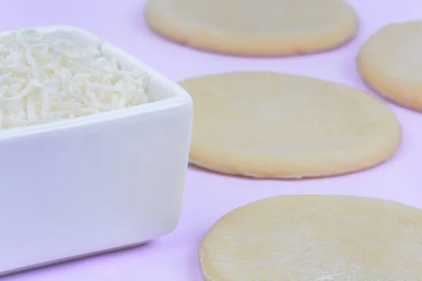 Dough and cheese on pink background — Stock Photo, Image