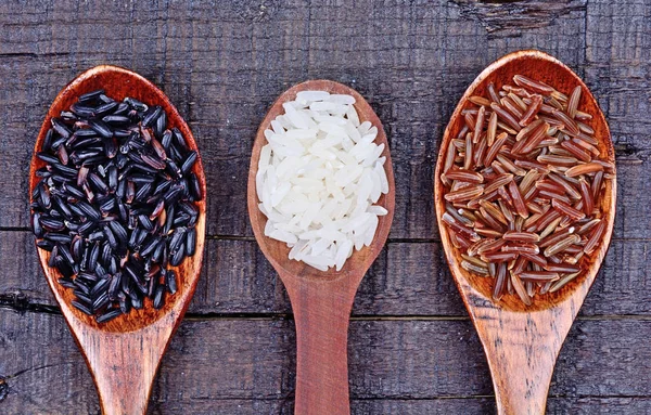 Spoon with different types of rice — Stock Photo, Image