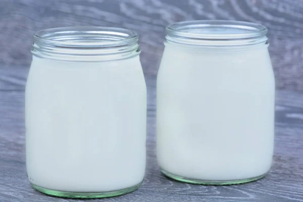Jars with yogurt on table — Stock Photo, Image