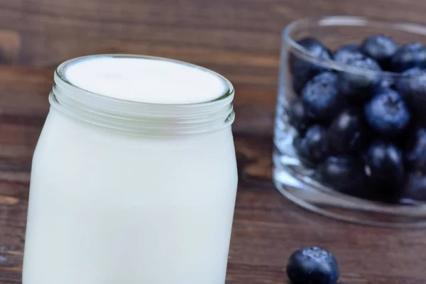 Joghurt mit Blaubeeren im Glas auf dem Tisch — Stockfoto