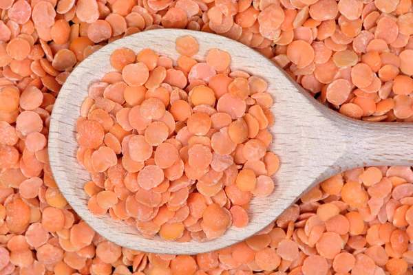 Red lentils in a wooden spoon — Free Stock Photo