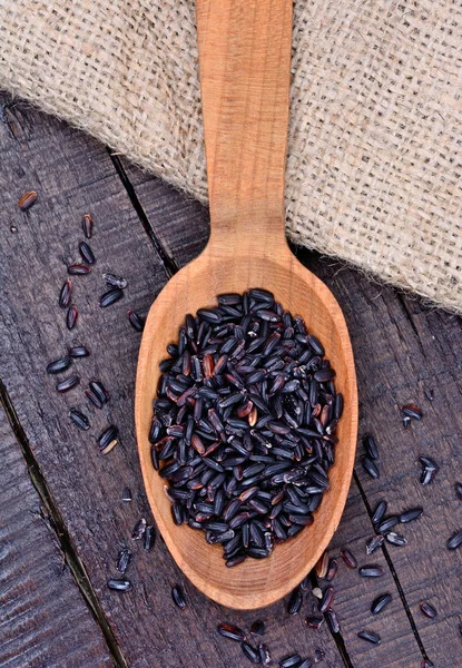 Black rice in a spoon — Stock Photo, Image