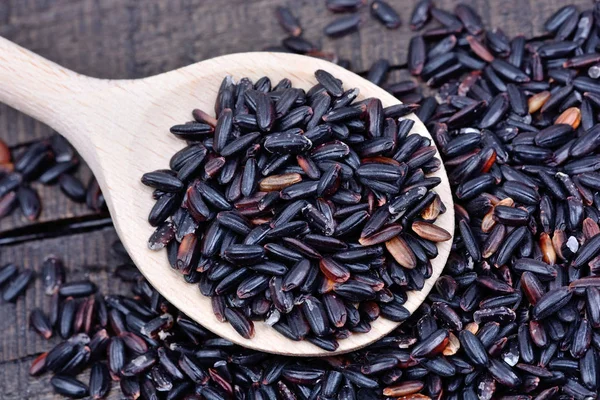 Rice in a wooden spoon — Stock Photo, Image