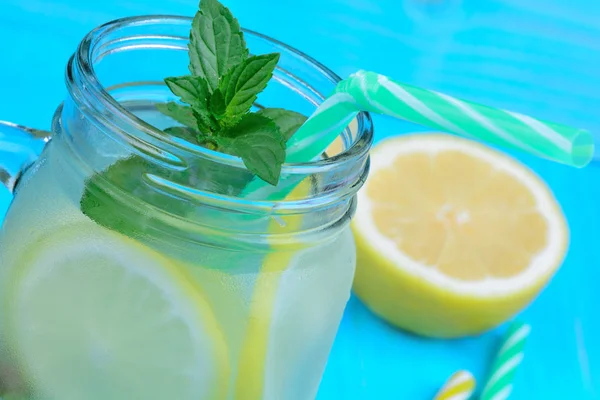 Lemonade in a glass jar on wooden table — Stock Photo, Image