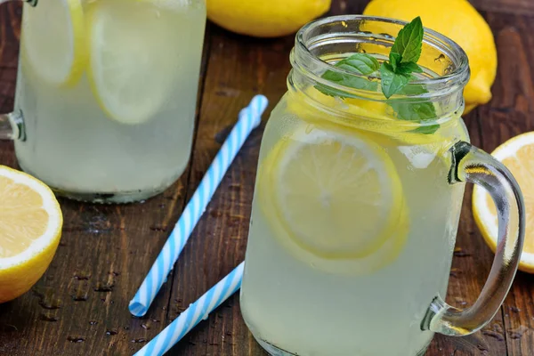 Mason jars with fresh lemonade on table — Stock Photo, Image