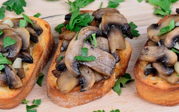 Group of mushroom bruschetta on table — Stock Photo, Image