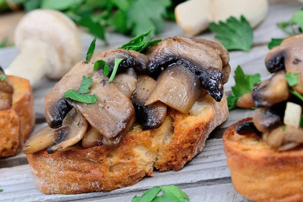 Heap of bruschetta with mushroom and garlic on table — Stock Photo, Image